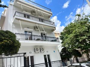 a white building with balconies on it at Hellenic Pleasure Residences in Athens
