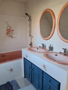 a bathroom with two sinks and two mirrors at Villa Bella à 300 m du Parc Fenestre in La Bourboule +17 photos