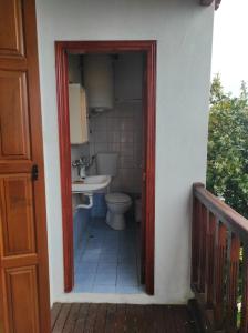 a bathroom with a toilet and a sink at Rita' s House Glossa Skopelos in Glossa