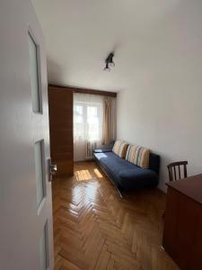 a living room with a couch and a window at Rose City Apartment in Oradea