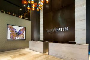 a lobby with a butterfly painting on the wall at The Westin Panama in Panama City