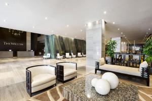 a lobby with couches and chairs in a building at The Westin Panama in Panama City