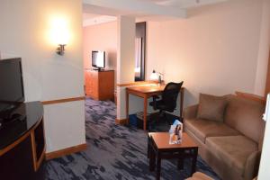a living room with a couch and a desk at Fairfield Inn & Suites by Marriott Sault Ste. Marie in Sault Ste. Marie