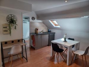 a kitchen and dining room with a table and chairs at Le Richelieu 3 chez Adrien in Saint-Quentin