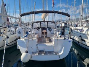 a white boat is docked in a harbor at Sail boat ANIMATO in Izola