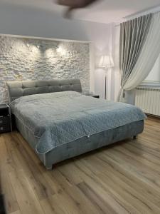 1 cama grande en un dormitorio con pared de ladrillo en Apartament de Lux Splendid, en Iaşi