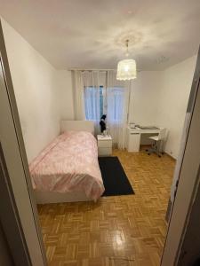 a bedroom with a bed and a desk and a window at Room only for women ! Uniquement pour femmes 