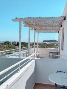 a balcony with a table and a view of the ocean at Lindos Athena in Lindos