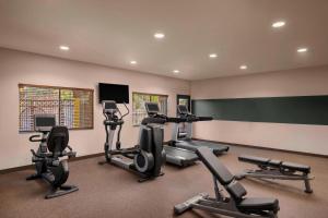 a gym with several exercise bikes and a chalkboard at Four Points by Sheraton Anaheim in Anaheim