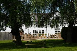 a picnic table under a tree in front of a house at Egerton Arms in Chester