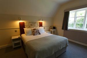 a bedroom with a large bed and a window at Egerton Arms in Chester