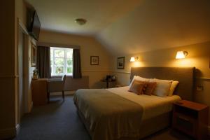 a hotel room with a bed and a window at The Egerton Arms in Chester