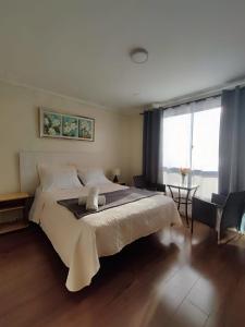 a bedroom with a large white bed and a window at Hotel 251 in Viña del Mar