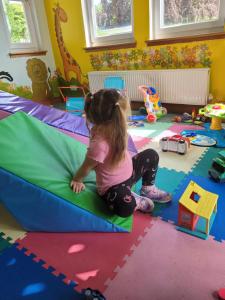 a little girl playing in a room with toys at The Sunny Bunny Holiday Home in Ballantrae