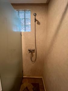 a shower in a bathroom with a window at Dar diafa samira in Mirleft
