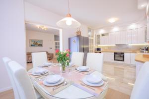 a kitchen and dining room with a table and chairs at Villa Sviba in Split