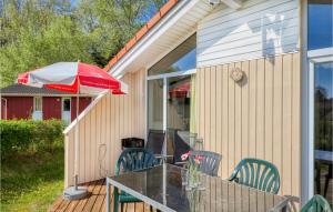 a patio with a table and an umbrella at Freibeuterweg 20 - Dorf 5 in Travemünde