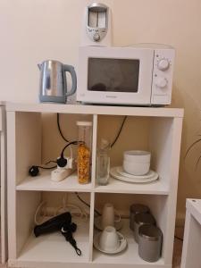 a microwave oven sitting on top of a white shelf at KELVIN HOUSE in Durham