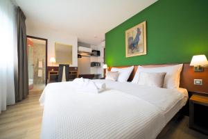 Postel nebo postele na pokoji v ubytování Tulip Inn Beaulieu Lausanne