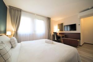 Postel nebo postele na pokoji v ubytování Tulip Inn Beaulieu Lausanne