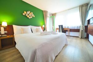 Postel nebo postele na pokoji v ubytování Tulip Inn Beaulieu Lausanne