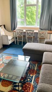 un soggiorno con divano, tavolo e sedie di Flat 1 a Hendon