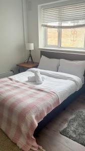 a bedroom with a large bed with a window at Flat 1 in Hendon