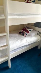 a white bunk bed with two pillows on it at Flat 1 in Hendon
