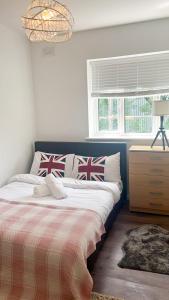 a bedroom with a bed with british pillows on it at Flat 1 in Hendon