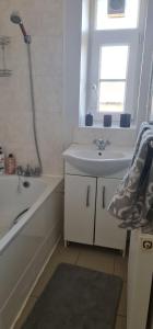 a bathroom with a sink and a tub and a shower at Stylish 2 Bed Flat in Hoxton near Art Galleries in London