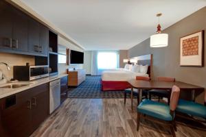 a hotel room with a bed and a kitchen and a table at TownePlace Suites Las Vegas Airport South in Las Vegas