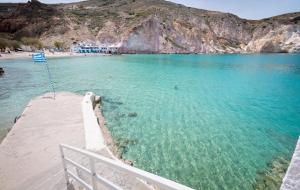 a view of a beach with people swimming in the water at Thavma Milos in Firopótamos