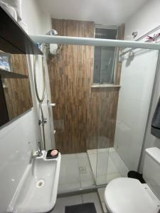 a bathroom with a shower with a sink and a toilet at Vai ser feliz in Rio de Janeiro