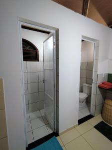 a bathroom with a shower and a toilet at Bangalô Panorâmica in Conde