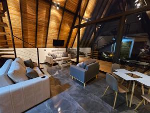 a living room with a couch and chairs and a table at Wind Houses, Casas de Viento in Monteverde Costa Rica