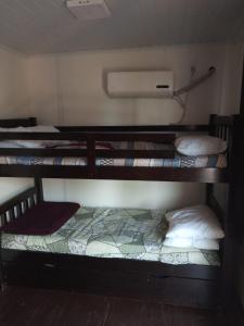 a group of bunk beds in a room at dream house in Punta Del Diablo
