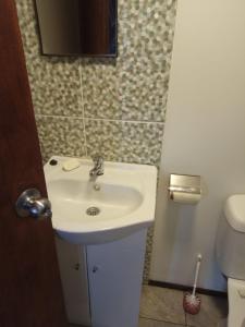 a bathroom with a sink and a toilet at dream house in Punta Del Diablo