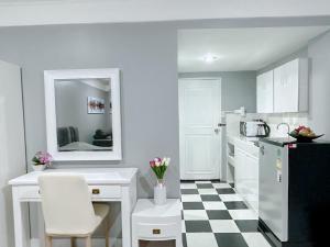 a kitchen with a black and white checkered floor at Sea sand sun Condominiums in Rayong