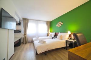 Postel nebo postele na pokoji v ubytování Tulip Inn Beaulieu Lausanne