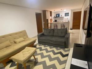 a living room with a couch and a chair at Apartamento Encantador em Bananeiras in Bananeiras