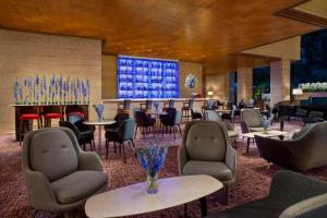 a hotel lobby with tables and chairs and a bar at Sheraton Towers Singapore Hotel in Singapore