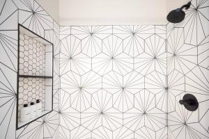 a bathroom with a tiled wall with a mirror at Entire house - 4 Bedroom & 2 Bath, 5 Min to Beach in Oceanside +33 photos