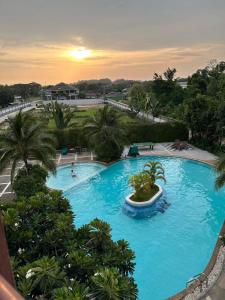 an overhead view of a large blue swimming pool at Sea sand sun Condominiums in Rayong