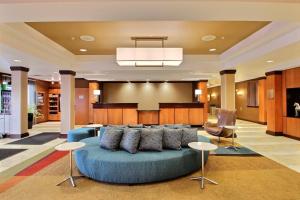 salon z niebieską kanapą w hotelowym holu w obiekcie Fairfield Inn & Suites by Marriott Milwaukee Airport w mieście Oak Creek