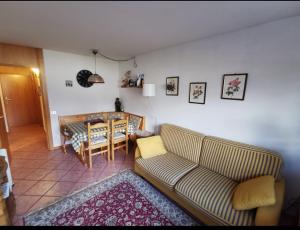 a living room with a couch and a table at Val di Sole Holidays in Folgarida