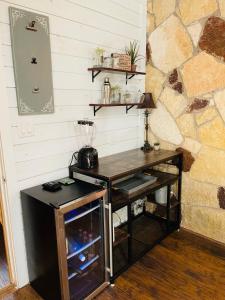 a desk in a room with a stone wall at Cypress Star in Bandera in Bandera