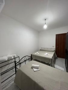 a room with two beds and two tables in it at Casa Nonna Rusell in Naples