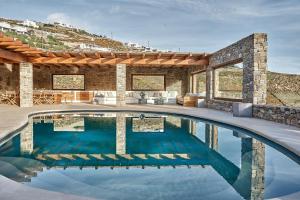 a swimming pool in the middle of a house at Christina's Panormos Villa in Mykonos