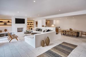 a living room with a couch and a table at Christina's Panormos Villa in Mykonos