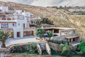 an aerial view of a house with a mountain at Christina's Panormos Villa in Panormos Mykonos